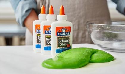 elmer's glue bottles and green slime on countertop