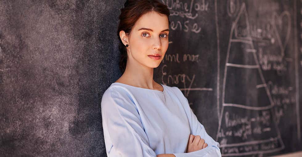 teacher standing in front of chalkboard
