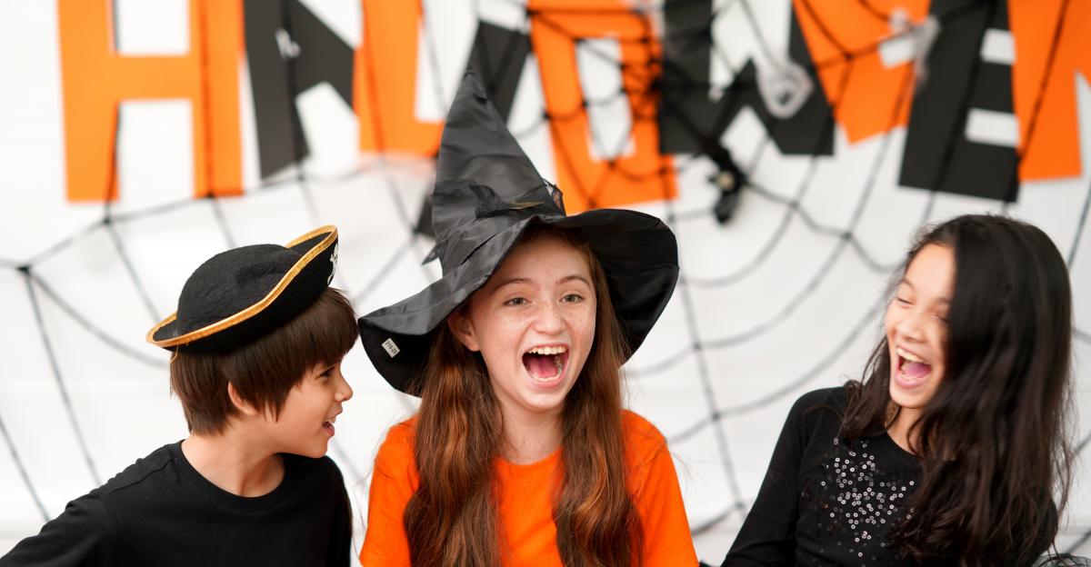 Kids laughing have fun to play games in Halloween celebration party at home