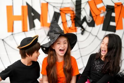 Kids laughing have fun to play games in Halloween celebration party at home
