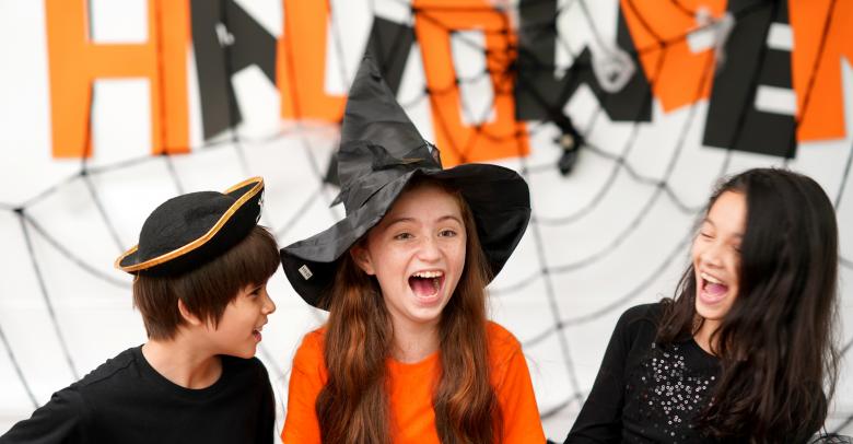 Kids laughing have fun to play games in Halloween celebration party at home