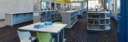 kranz junior high school library with full bookshelves and table with chairs