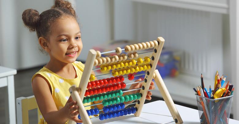 early childhood student counting with abacus