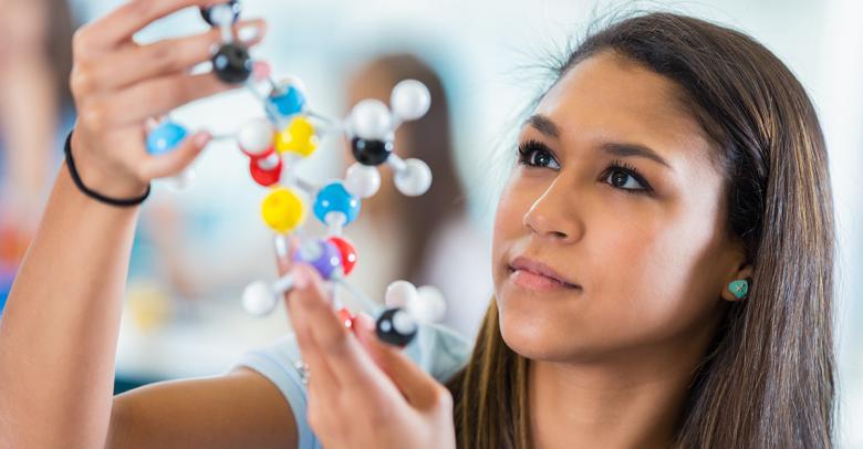 high school student studying atomic model in science classroom