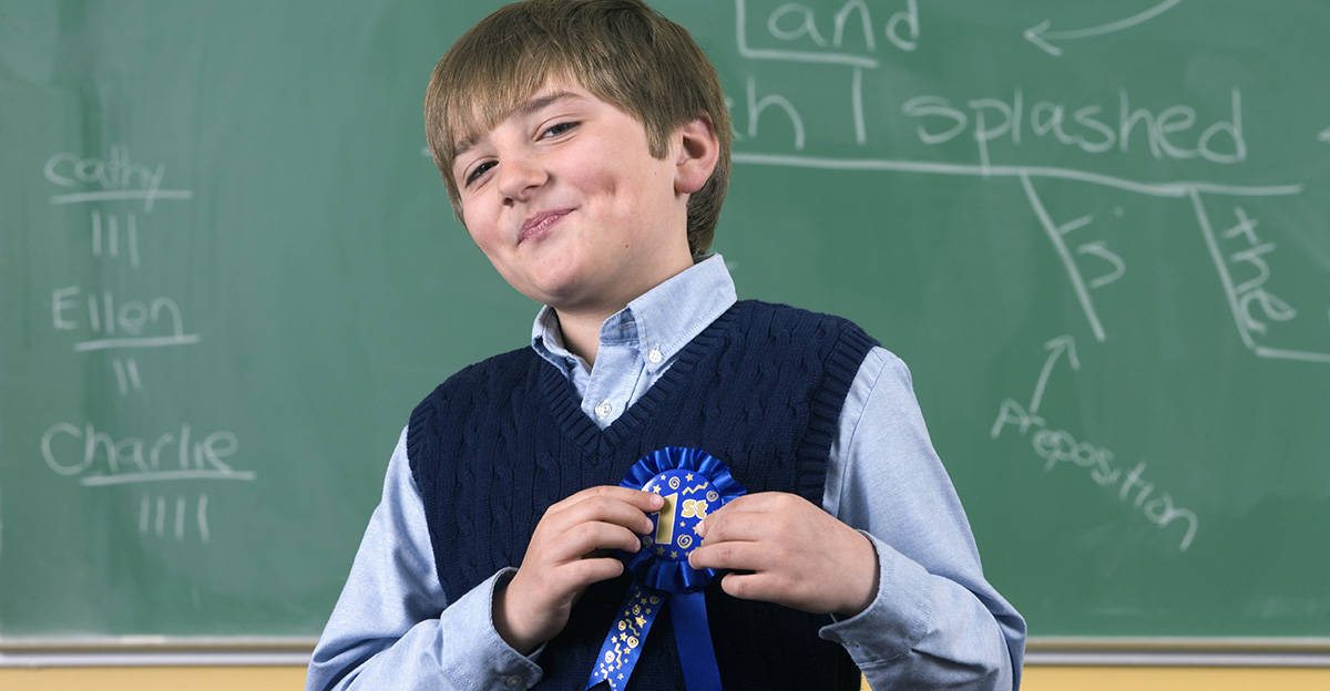 student wearing reward ribbon for achievement