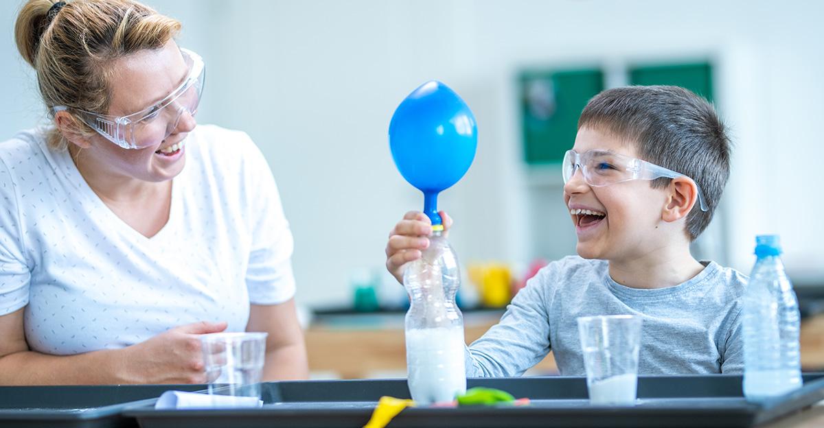 young student doing chemistry experiment with balloons