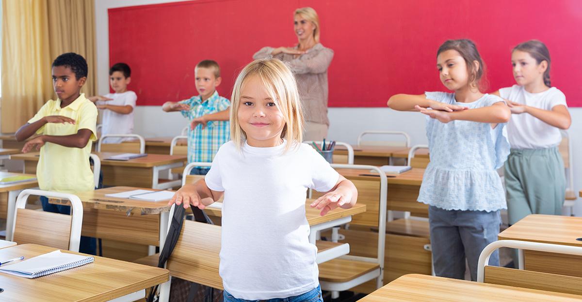 children and teacher taking physical activity break in classroom