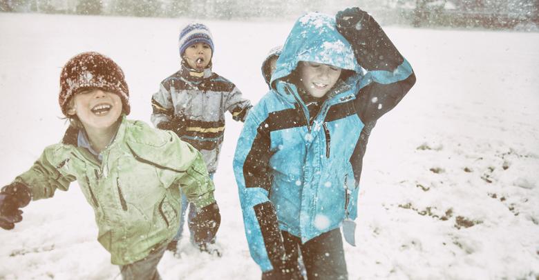 laughing children playing in the winter snow