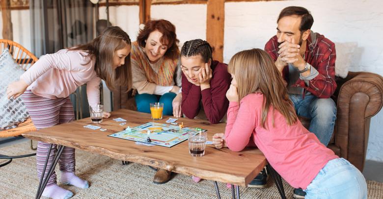 family with kids playing board games