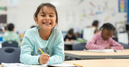 young student practicing her writing