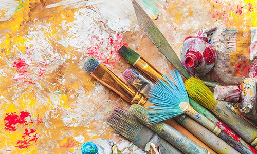 painting tools on colorful abstract autumn background