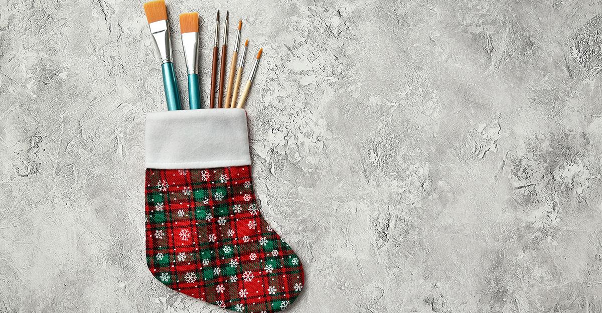 winter art paint colors and brushes in a holiday stocking