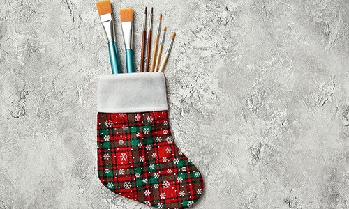 paintbrushes in a holiday stocking