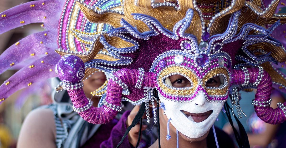 person wearing colorful mask and headdress for the fall masskara festival in the phillippines