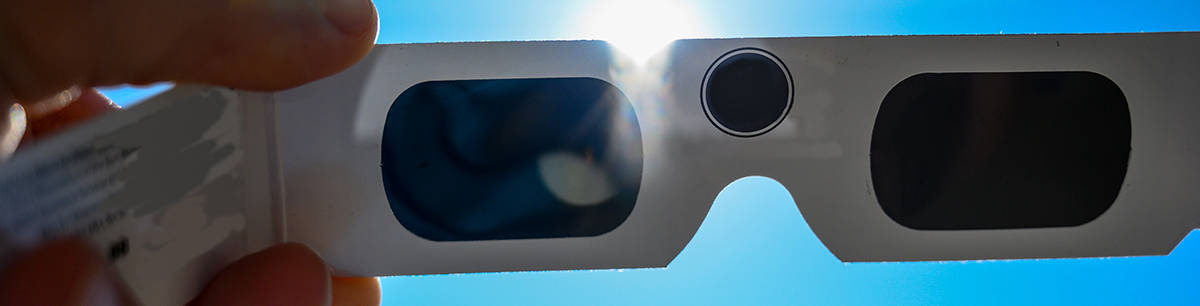 solar eclipse safety glasses blocking out the sun