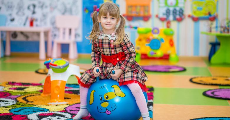 little girl using ball chair in active learning environment