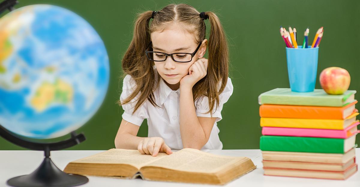 young girl studying geography lesson with books and a globe