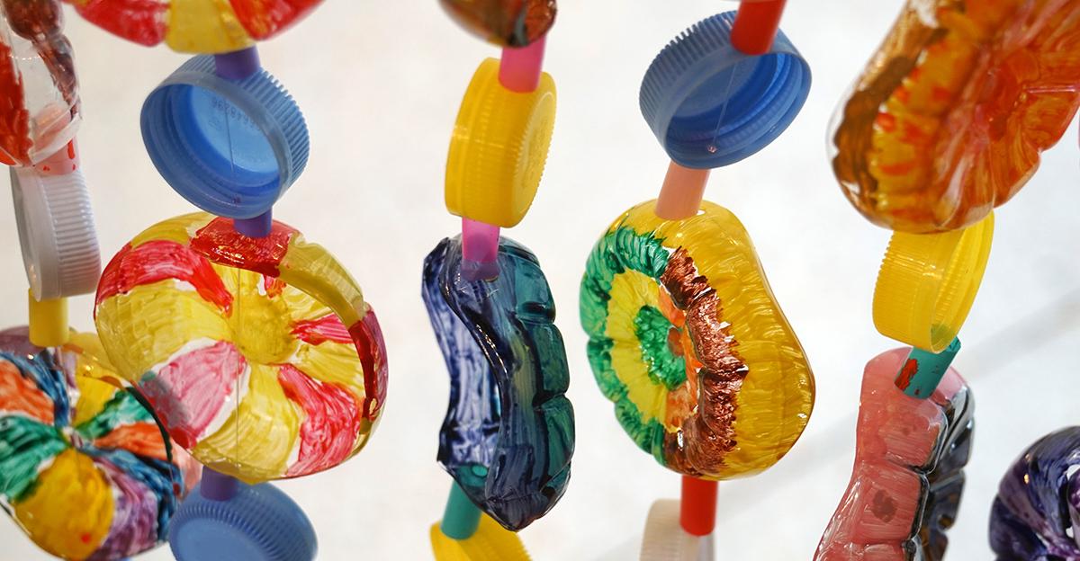 art design made by stringing together recycled parts of plastic bottles