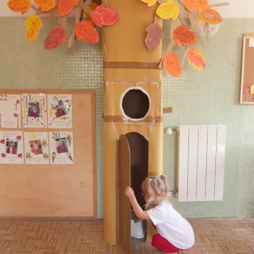 classroom decoration of cardboard tree with colorful fall leaves