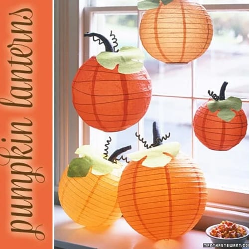 round orange paper lanterns with added stem decorations to make them look like pumpkins