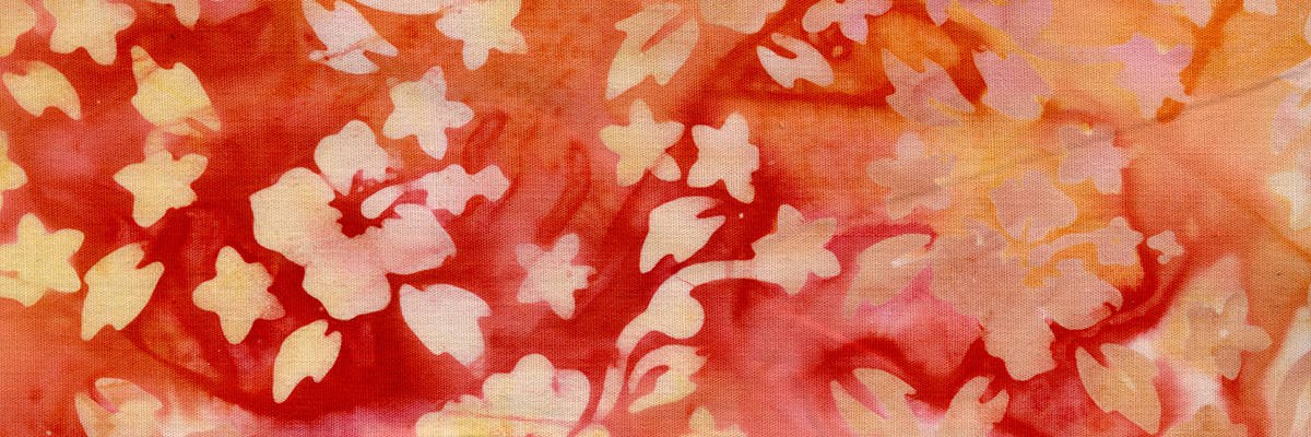 red, orange, and yellow hibiscus design pattern on fabric