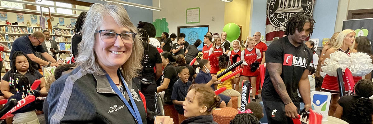 teacher and students at a school library makeover reveal event