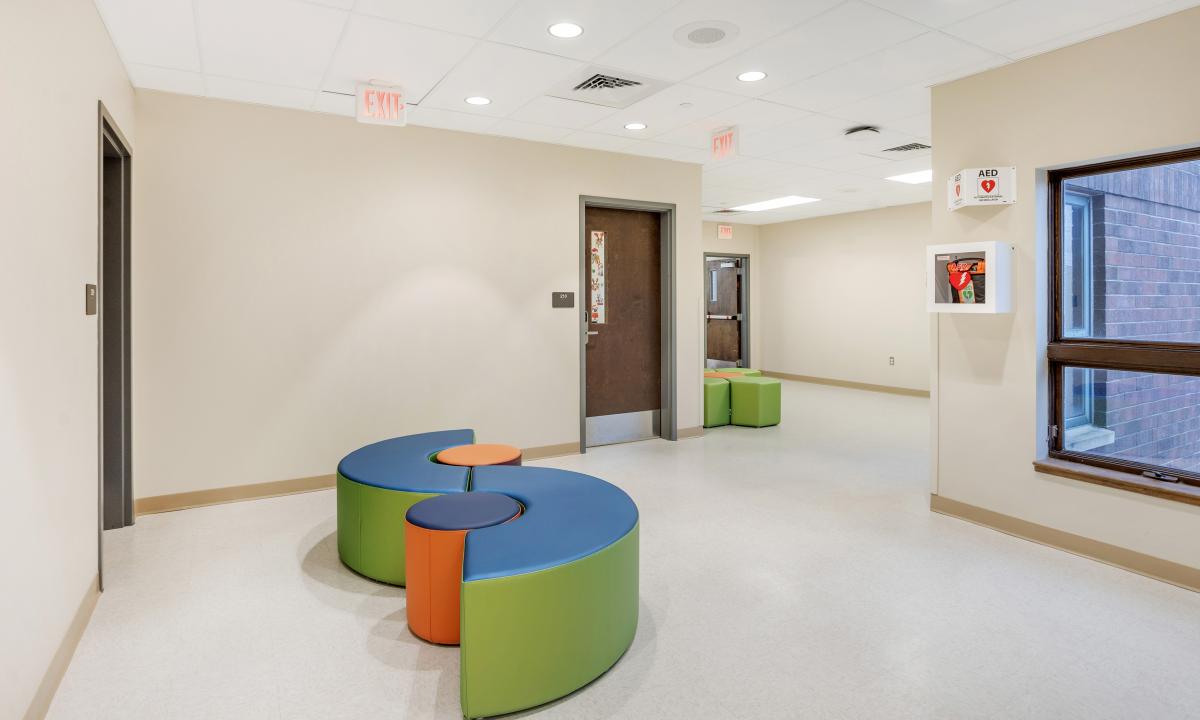 school hallway with soft seating areas, alternate angle