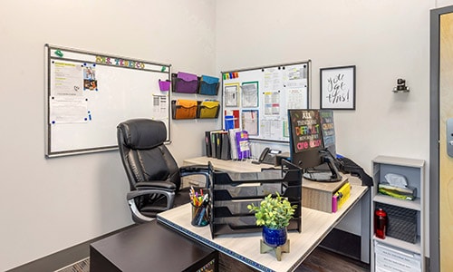 teacher's office with desk, chair, and supplies
