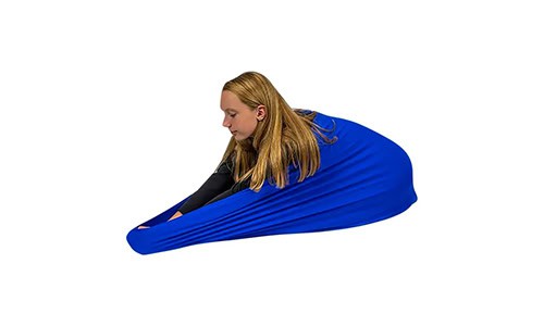 girl leaning forward with a blue deep pressure body sock around her