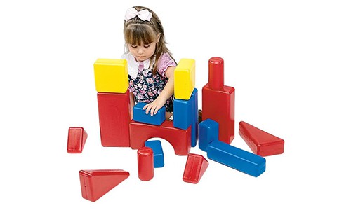 little girl playing with large colorful blocks 