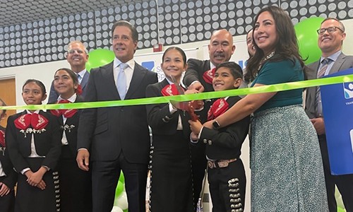 educators help two students cut the ribbon at an unveiling of the school's new mariachi room