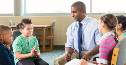 elementary students talking to the school principal