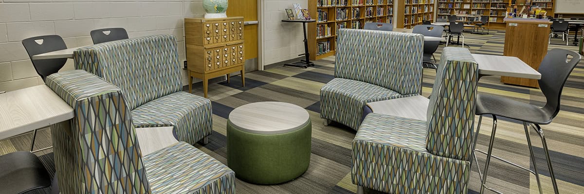 soft seating and shelves of books in a school library