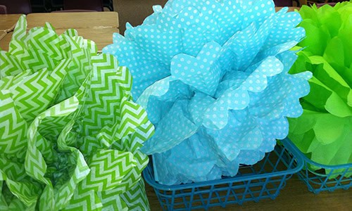 baskets on a desk decorated with blue and green decorative paper