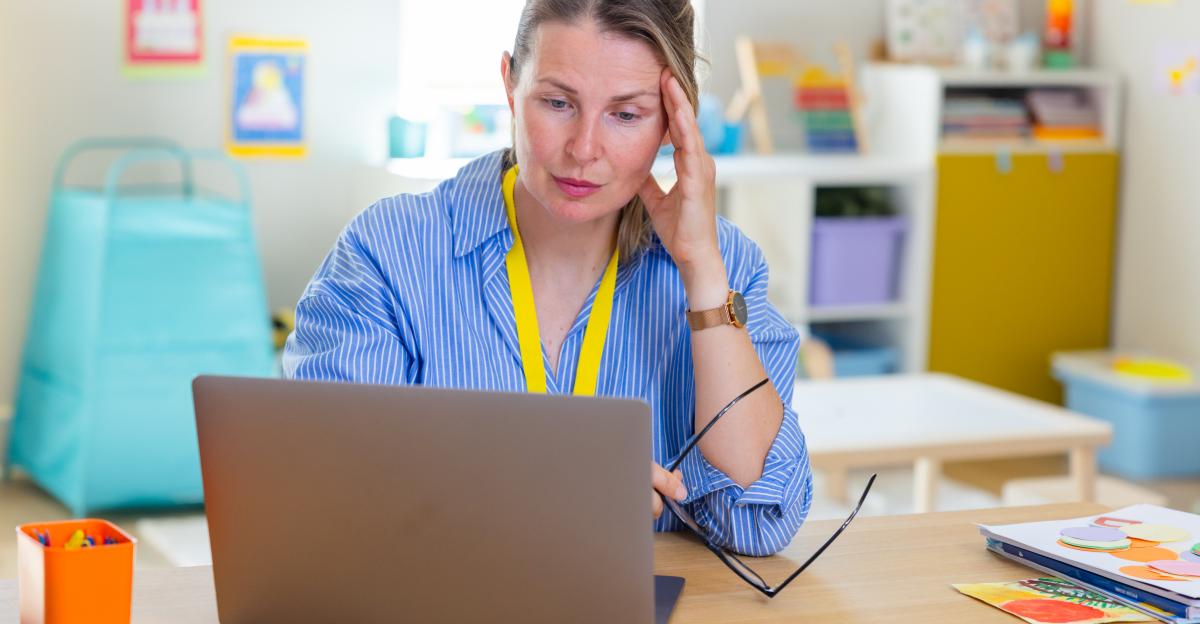 Woman working in daycare with laptop while stressed